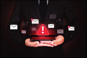 Person holding a phone surrounded by fraudulent email alerts.