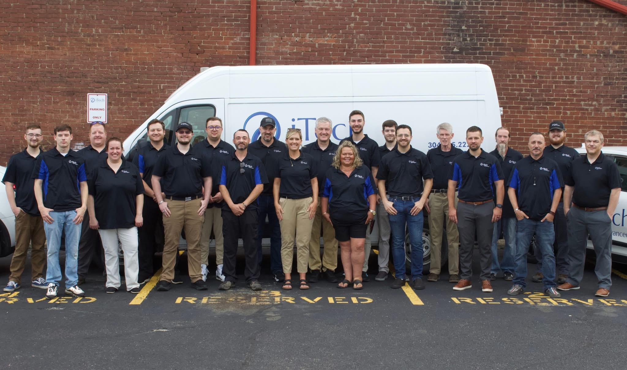 iTech Team Smiling and Standing in the Office