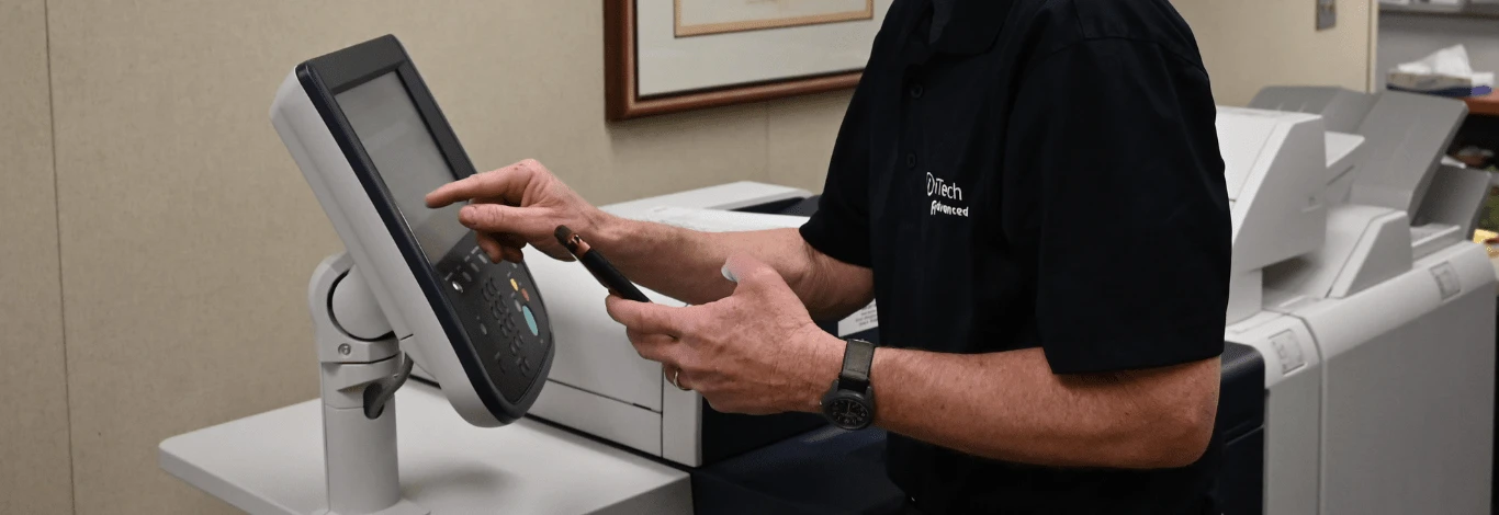 iTech representative demonstrating advanced Xerox printer technology to improve business efficiency.